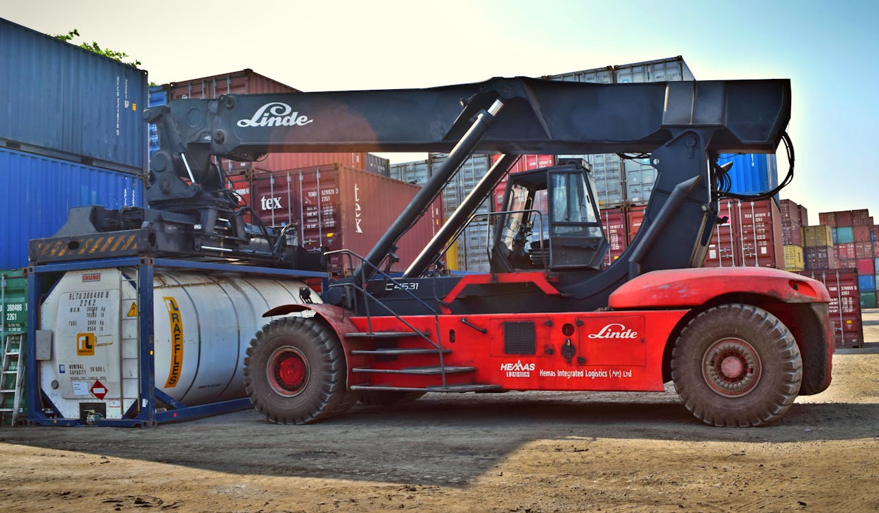 Past Performance Forklift operating at a cargo yard, moving large containers efficiently.